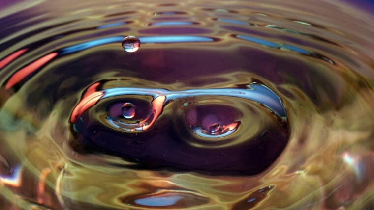 Droplets are falling on a water surface.