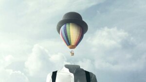 Illustration of a hot air balloon wearing a hat and ascending from a body into the sky