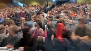Blurred image of a lecture theatre full of students