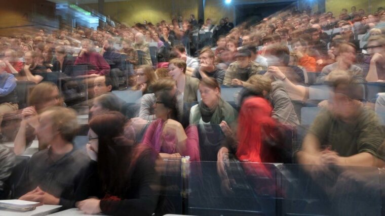 Blurred image of a lecture theatre full of students