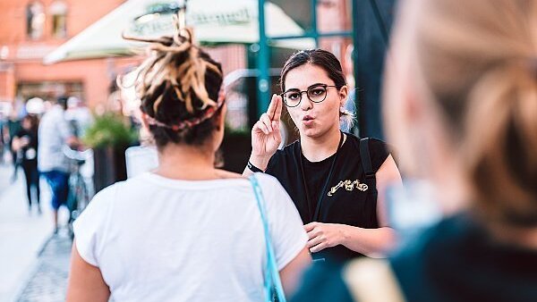 Two young women have a conversation in sign language