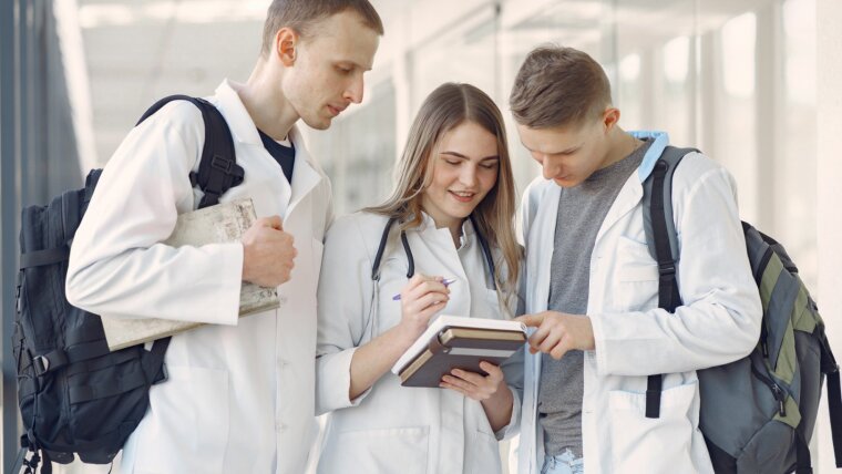 Medical students stand together in a hallway