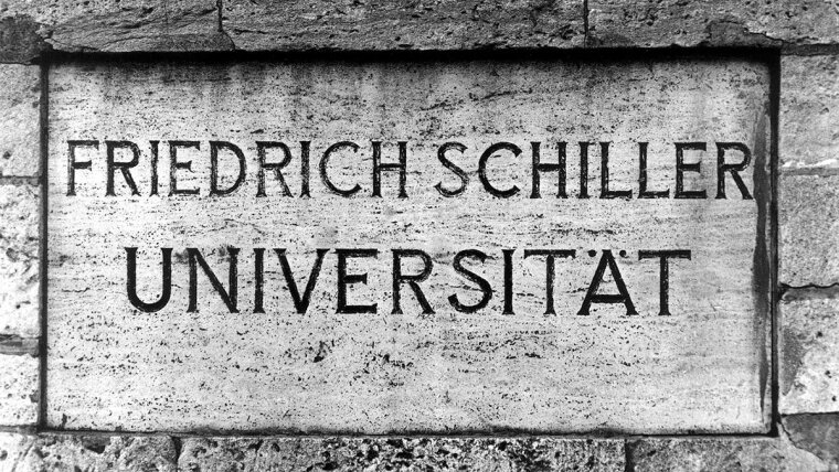 In Stein gemeißelter Namenszug "Friedrich-Schiller-Universität" am Universitätshauptgebäude.