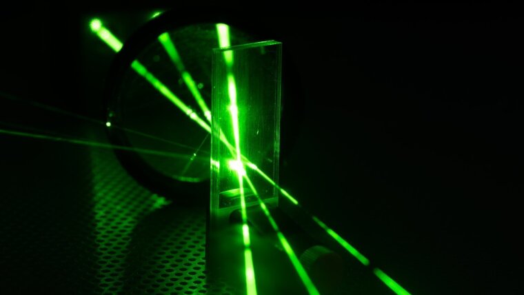 Green laser on optical table in a quantum optics lab