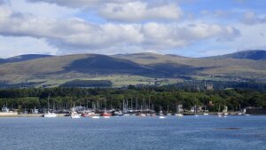 view of boats, sea, and Eryri mountains from Bangor Pier