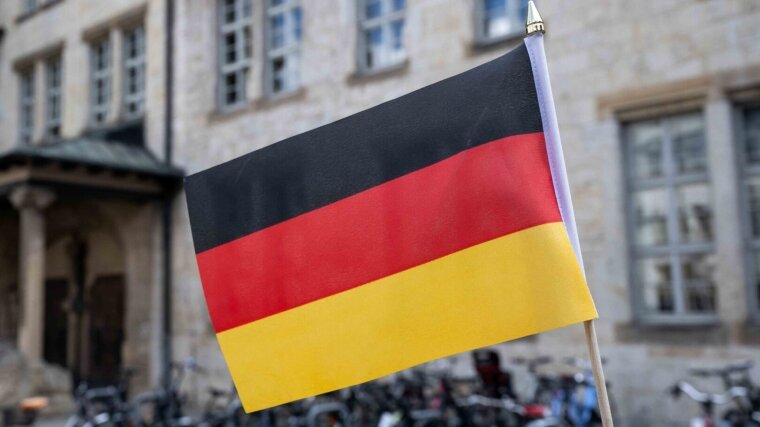German flag in front of the university main building.