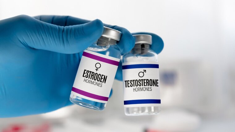 Two injection vials for treatment with Testosterone and Estrogen hormones.