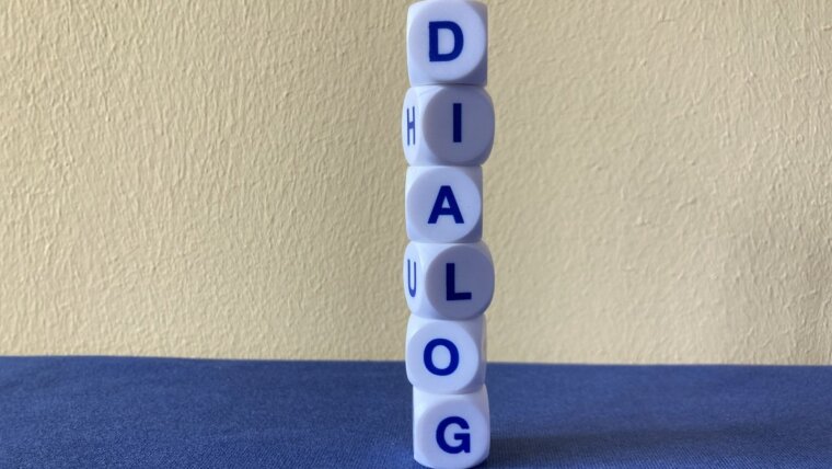 letter cubes form the word 'dialogue'