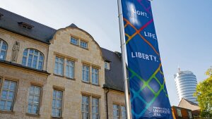 A flag with the slogan ‘Light, Life, Liberty’ on the main university building.