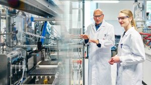 Prof. Dr Ulrich S. Schubert and Dr Natalie Göppert in front of a synthesis robot for automated copolymerisation.