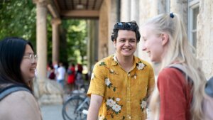 Drei Internationale Studierende beim Fahrradständer am UHG