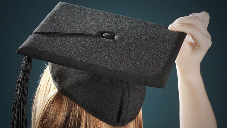 Female doctoral candidate with a doctoral hat