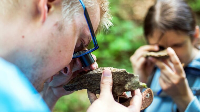 Rocks are carefully analyzed during an excursion